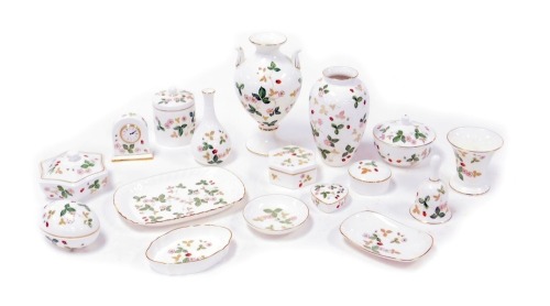 A group of Wedgwood porcelain Wild Strawberry pattern ornaments, including boxes and covers, vases, a bell, bedside clock, and an egg shaped box and cover. (a quantity)