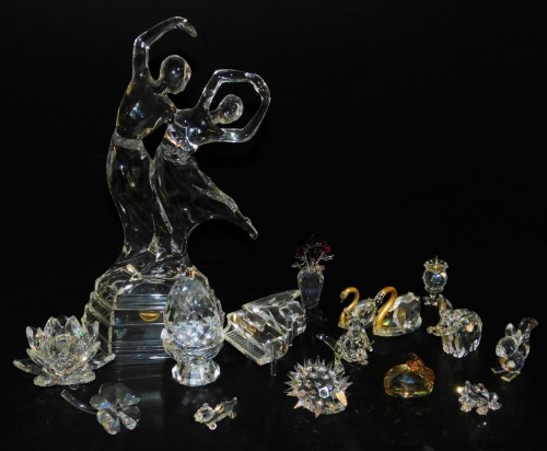 A group of Swarovski crystal animals, including a hedgehog, elephant, and a kangaroo, a grand piano, candle holder, vase of flowers, etc., together with RCR glass figure group of a pair of dancers. (a quantity)