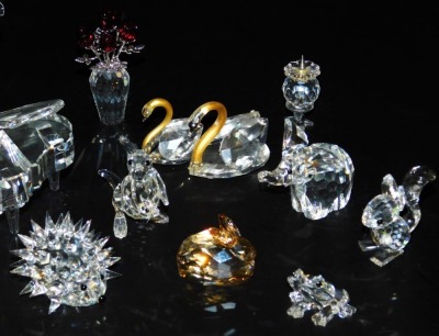 A group of Swarovski crystal animals, including a hedgehog, elephant, and a kangaroo, a grand piano, candle holder, vase of flowers, etc., together with RCR glass figure group of a pair of dancers. (a quantity) - 2