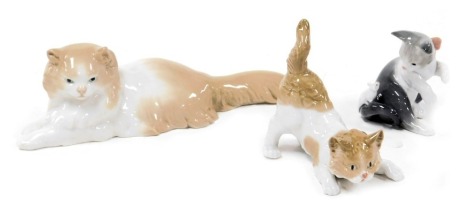 A Lladro porcelain figure of a recumbent cat, and two figures of kittens. (3)