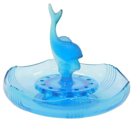 An Art Deco blue glass centrepiece, of three sectional form, with a dolphin, inserted into a flower holder, within a shaped bowl, 28cm wide.