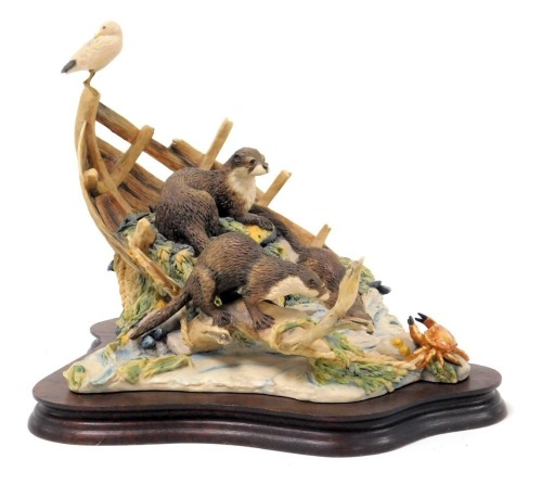 A Border Fine Arts sculpture of otters, in a coastal setting, with crab and seagull, limited edition 781/850, on a wooden stand.