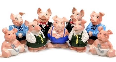 A group of Wade NatWest piggy banks, comprising two fathers and mothers, a boy, two girls and two babies. (9)