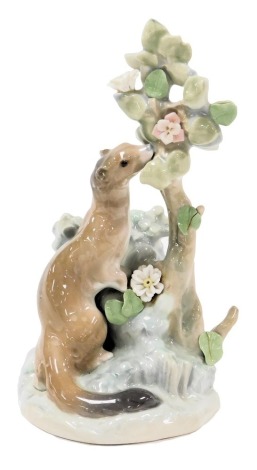 A Lladro porcelain figure of an Ermine, against a tree with flowers, on a naturalistic base, 24cm high.