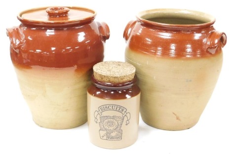 A pair of two tone stoneware crock pots, one with lid, 34cm high, together with a two tone biscuit jar, with a cork bung. (3)