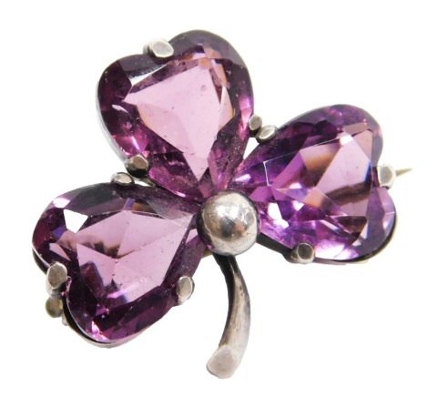 An Edwardian silver and amethyst paste set brooch, formed as a three leaf clover, or shamrock, Charles Horner, Chester 1906.