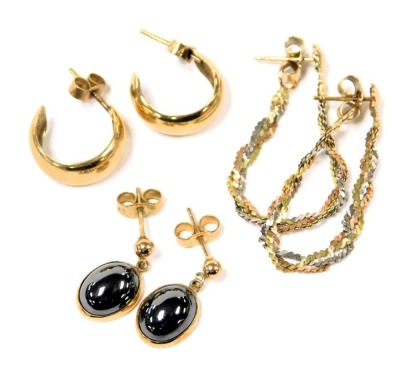 A pair of three colour drop earrings, together with a pair of hoop earrings, and a pair of oval black cabochon earrings, set in yellow metal, some stamped 9ct, 6.7g.