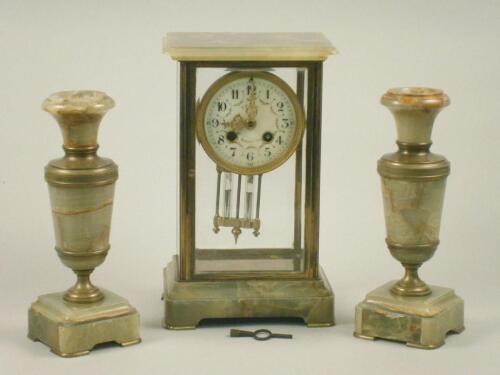 A late 19thC French onyx and brass mantel clock garniture