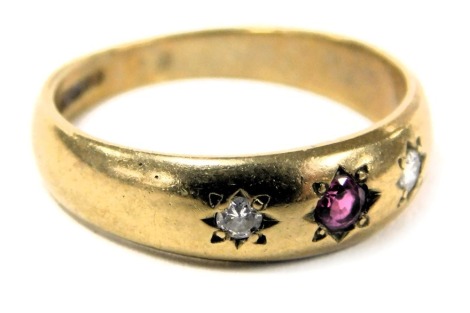 A 9ct gold ruby and diamond three stone gypsy ring, in a rub over setting, size L, 2.7g.