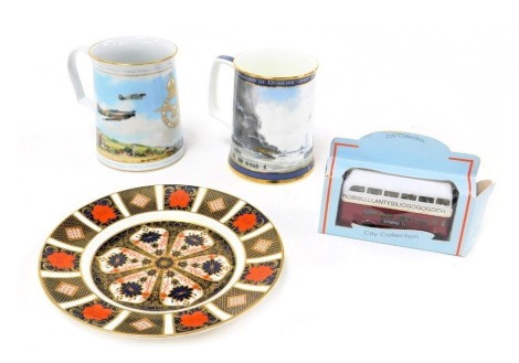 A Royal Crown Derby Old Imari porcelain plate, 21.5cm wide, Royal Doulton Dunkirk tankard, limited edition 1348/14750, and a Flying for Victory tankard, for the Royal Air Force Museum, together with a diecast model of a Welsh double decker bus. (4)