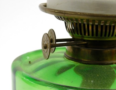 An early 20thC cast iron oil lamp, with a green glass reservoir, glass chimney and etched glass shade, 55cm high. - 2