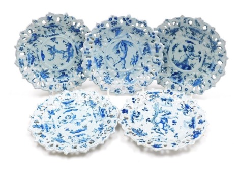 Five late 19thC Cantagalli blue and white pottery ribbon plates, decorated centrally with cherubs, within a border of flowers, and reserves of Italian rustic buildings and fishing vessels, painted marks, 24cm wide.