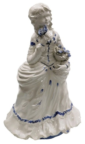 A Capodimonte figure of a girl, standing in Victorian costume with a basket of flowers and a rose, printed mark, 69cm high.