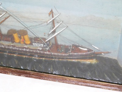 A late 19thC diorama of a sailing ship "India", modelled with three masts, sails furled and under steam, with figures on the decks, on a sea with lighthouse and blue sky beyond, glass and wooden cased, case 40cm high, 79cm wide. - 2