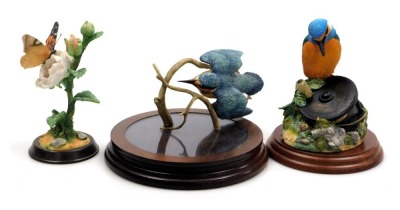 A Border Fine Arts sculpture modelled as Kingfisher and Fishing Reel, another of a kingfisher with a branch, and a Butterflies figure of Painted Lady on Rose, all on wooden stands. (3)