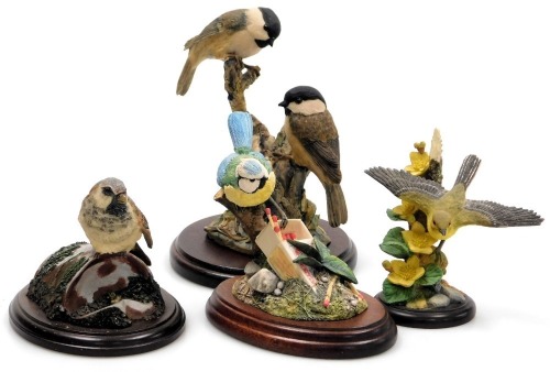 A Border Fine Arts sculpture of Willow Tits, another of a Yellow Wagtail, together with a Chiltern figure of Blue Tit on a matchbox, and a Teviotdale figure of a Sparrow on a tin can, all with wooden bases. (4)