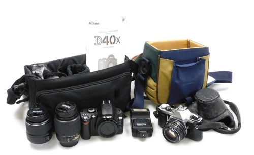 A Pentax ME camera, Praktica 1600A flash, Nikon D40X camera, with additional lenses, both with carry cases.