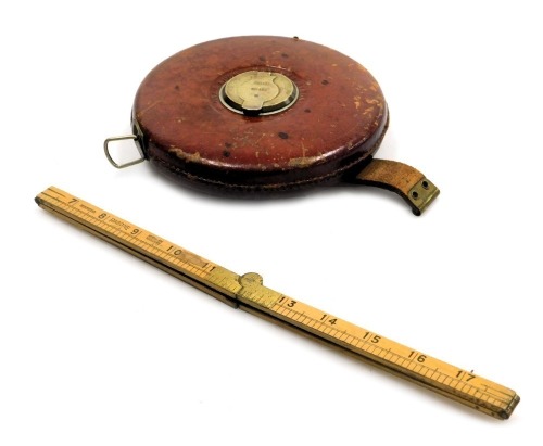 A Rabone 200ft tape measure, leather cased, number 418, together with a Rabone folding ruler. (2)