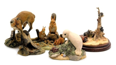 A Border Fine Arts sculpture of raccoons, another of a seal pup, a fox atop a tree bough, and a Chiltern sculpture of Family Life, squirrel family, WW15