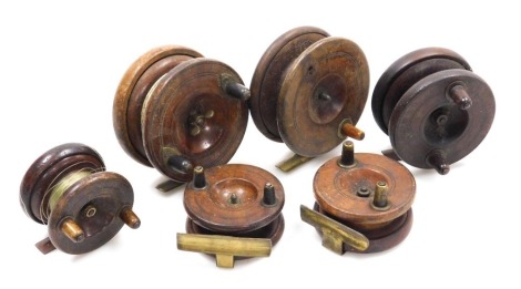 Three vintage Nottingham style mahogany centre pin reels, varying sizes, all with brass fittings.