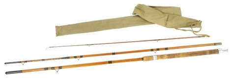 A vintage bamboo and fibreglass three piece fishing rod by AE Rudge and Son of Redditch, with canvas case.