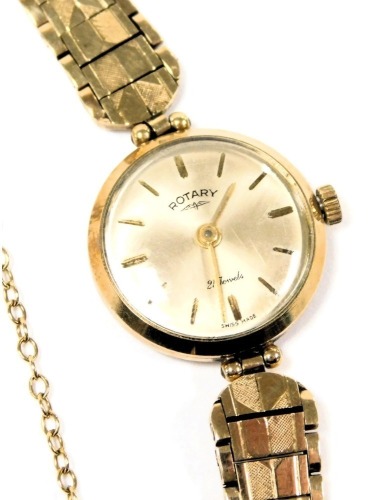 A Rotary lady's 9ct gold cased wristwatch, circular champagne dial with batons, twenty one jewel movement, on a 9ct gold strap, with safety chain as fitted, 16.6g all in.