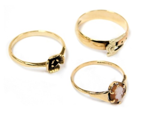 A 9ct two colour gold band, in a belt and buckle design, size N, a 9ct gold and shell cameo ring, bust portrait of a lady, size N, and a 9ct gold and garnet single stone ring, in a flower head setting, size N, 4.7g.