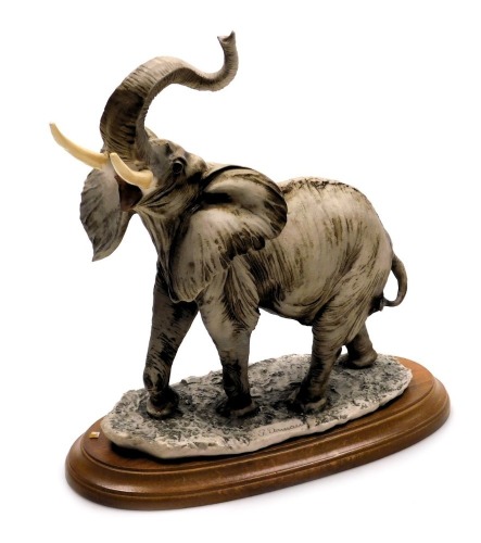 A Giuseppe Armani Capodimonte porcelain figure of an elephant, on a wooden base, with certificate, 23cm wide.