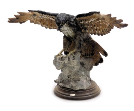 A Capodimonte porcelain figure of a bird of prey, raised on a wooden base, 33cm wide.