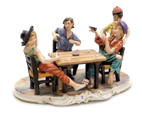 A Capodimonte porcelain figure group of card players, four urchin boys seated around a table, on a rococo base, with certificate, 39cm wide.