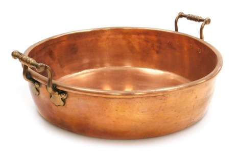 A Victorian copper preserving pan, with twin brass handles, 48cm wide.