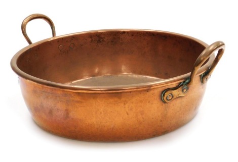 A Victorian twin handled copper preserving pan, 51cm wide.