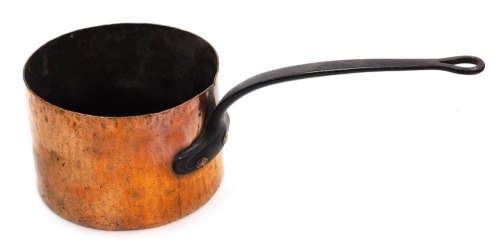 A 19thC copper saucepan, with a cast iron handle, stamped BR, 26cm wide.