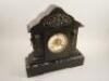 A French black slate and variegated marble mantel clock