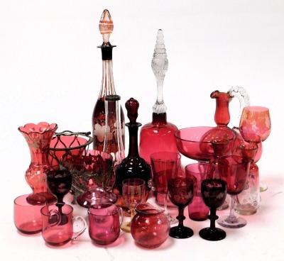 A group of Victorian and later cranberry glassware, including a bell, decanters, cranberry wine glasses, pedestal dishes, and custard cups. (a quantity)