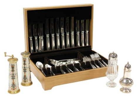 A silver plated canteen of cutlery, cased, cut glass sugar sifter with plated lid, further plated sifter, Lenox porcelain and brass salt grinder, and pepper mill. (5)