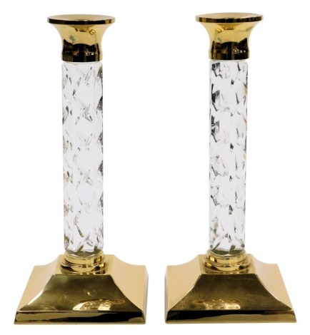 A pair of Waterford crystal and brass candlesticks, etched mark, 27cm high.