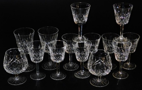 A group of Waterford crystal Lismore pattern table glass ware, comprising ten long stemmed white wine glasses, pair of red wine glasses, and a pair of brandy balloons.