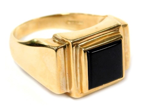 A gentleman's 9ct gold and black onyx ring, in a square stepped design, size Z, 8.2g.