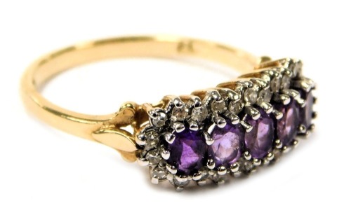 A 9ct gold amethyst and diamond ring, set with five amethysts in a surround of diamonds, size N, 2.6g.