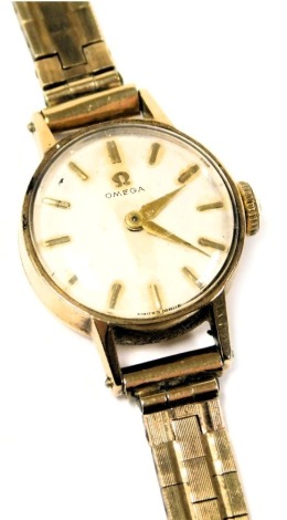 An Omega lady's 9ct gold cased wristwatch, the circular white dial with batons, on a brick link bracelet, boxed, 19.7g all in.