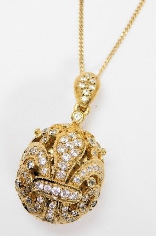 A silver gilt and paste set egg shaped pendant, opening to reveal "Je T'aime 2000", on a fine curb link neck chain.