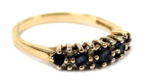 A 9ct gold and sapphire five stone ring, set with pairs of diamonds at intervals, size N, 2.1g.