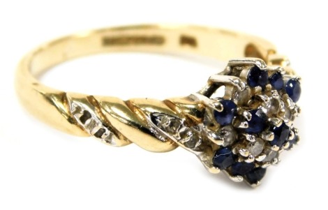 A 9ct gold sapphire and diamond ring, in five row flower head design, with diamond set shoulders, size N, 2.4g.