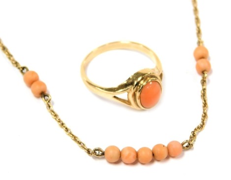 A 9ct gold and coral ring, size O, and a neck chain set with coral beads at intervals, on a bolt ring clasp, stamped 9ct, 4.6g.