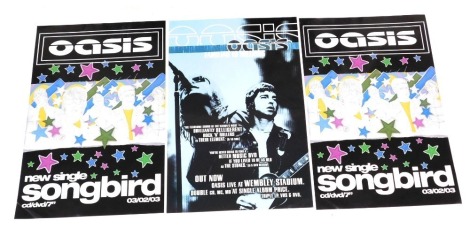 Three Oasis record shop posters, that were never used, Familiar to Millions-2000 Wembley Stadium, and Songbird 2002. (2)