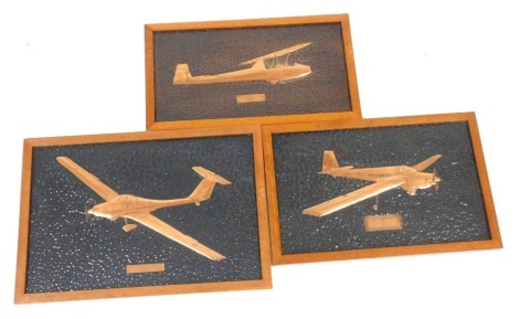 Three late 20thC hammered and embossed copper plaques, of Air Cadets planes, wooden framed, comprising Kirby Cadet MK III Syerston 1984, 22cm x 42cm, Venture T61F Syerston 1984, 26cm x 42cm, and Vigilant T MK I, 31cm x 46cm.