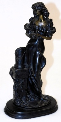 A 19thC patinated metal figure of a lady, modelled standing holding a bird, beside a plinth, raised on an oval base, 31.5cm high, together with a late 19thC bronze twin handled urn, embossed with dragonflies, 14cm high. (2) - 2