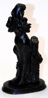 A 19thC patinated metal figure of a lady, modelled standing holding a bird, beside a plinth, raised on an oval base, 31.5cm high, together with a late 19thC bronze twin handled urn, embossed with dragonflies, 14cm high. (2) - 3