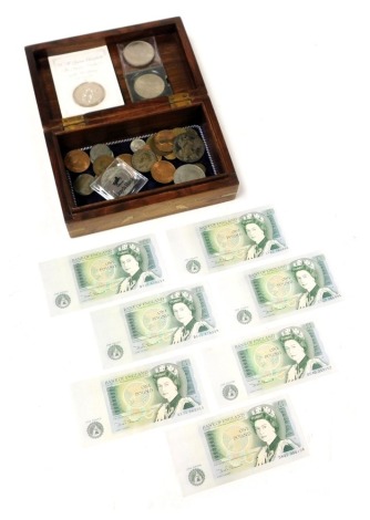 A wooden and brass inlaid box, containing a Maria Theresa thaler 1780, commemorative crowns, Millennium five pound coin, and further coinage, together with seven one pound notes, mint and uncirculated, Chief Cashier DHF Somerset.